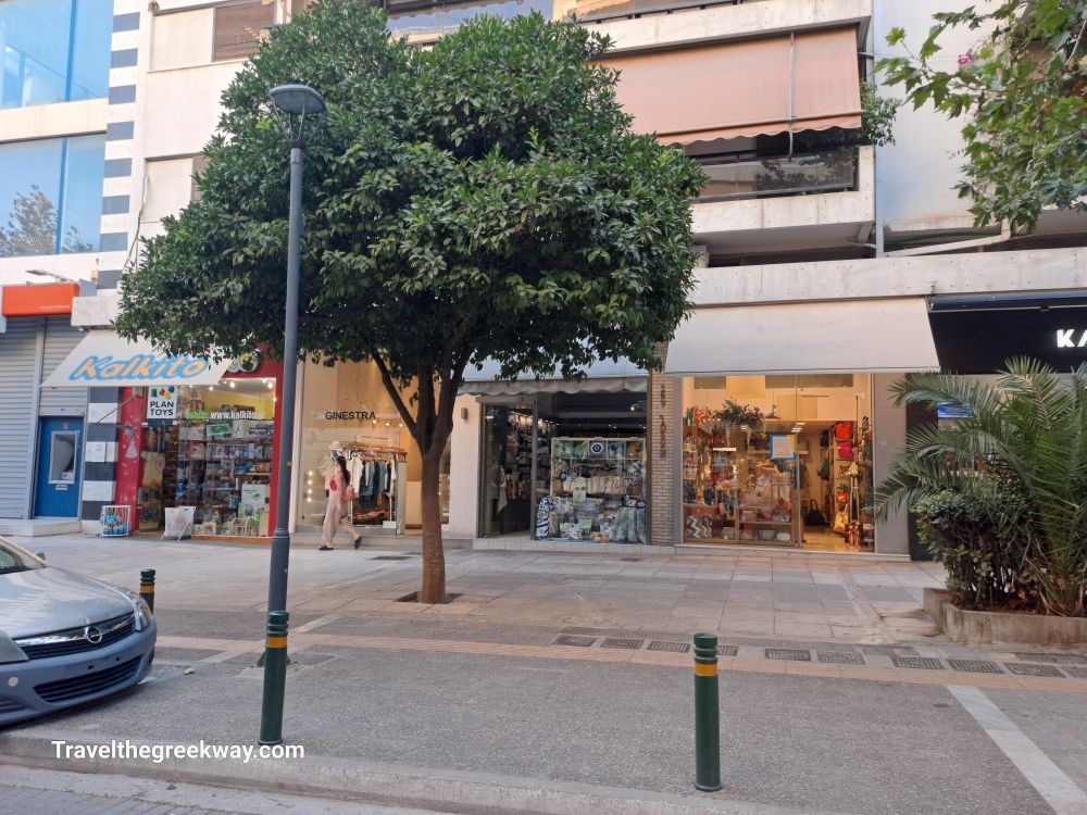 Small shops on a quiet street in Paleo Faliro, including a toy store and a boutique.