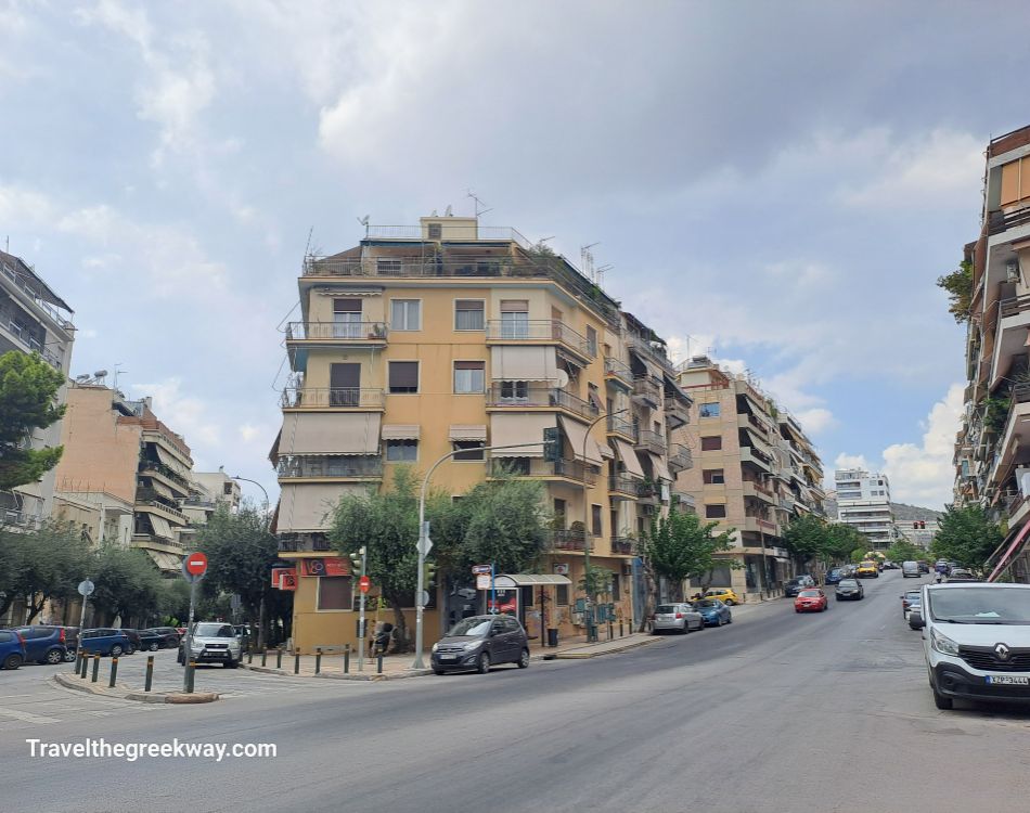  A busy intersection in a residential area of Athens, with a mix of old and modern buildings.