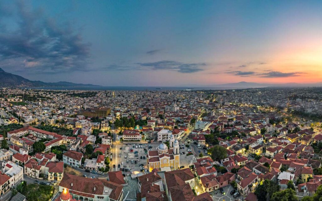 anoramic view of Kalamata town at sunset, showcasing the sprawling cityscape and coastline in the Peloponnese.