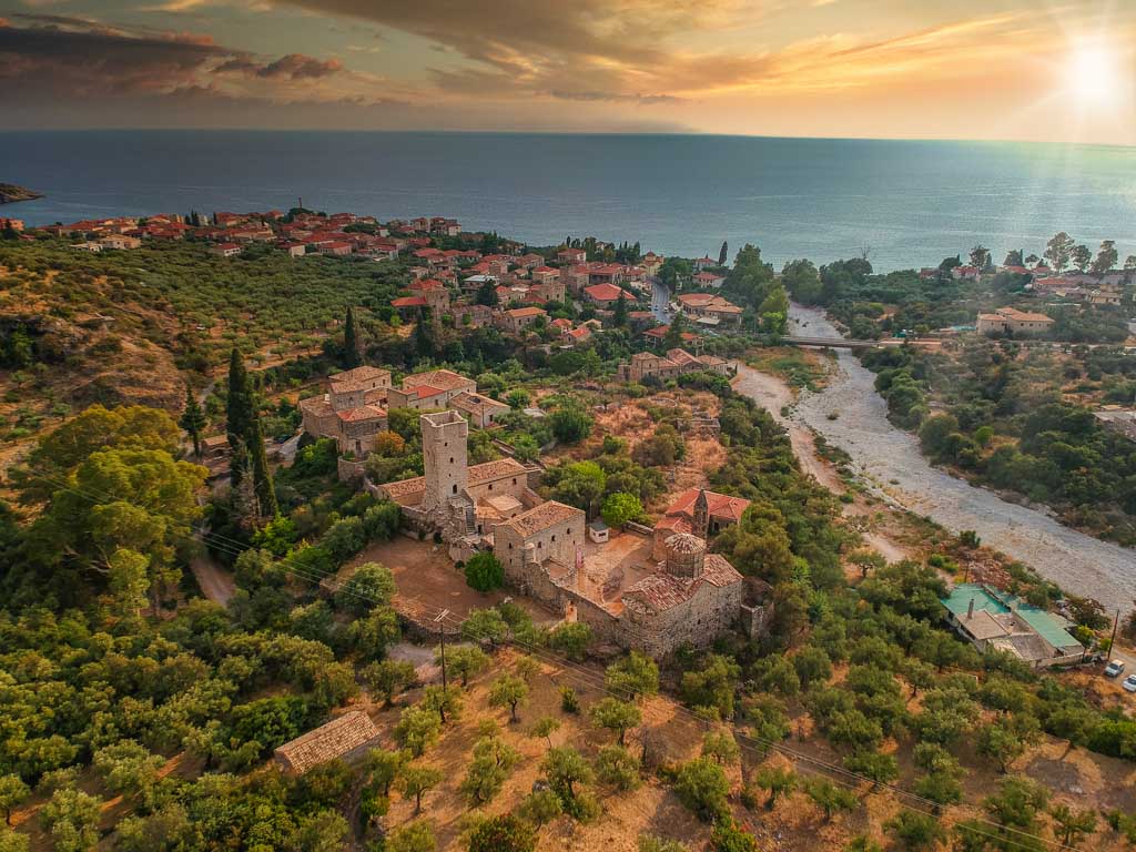 Aerial view of the picturesque village of Kardamyli in the Peloponnese, surrounded by lush greenery and the sea.