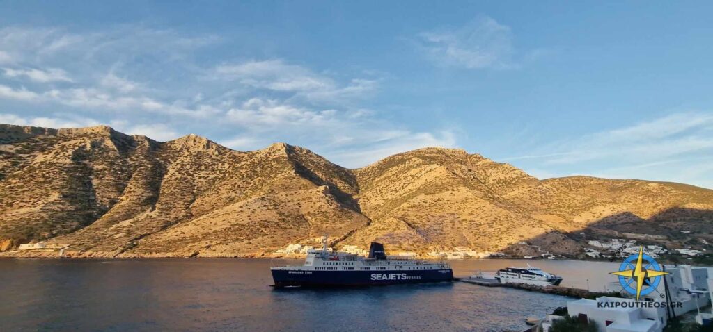 SeaJets ferry arriving at Sifnos island port, surrounded by mountainous scenery and a quiet harbor.