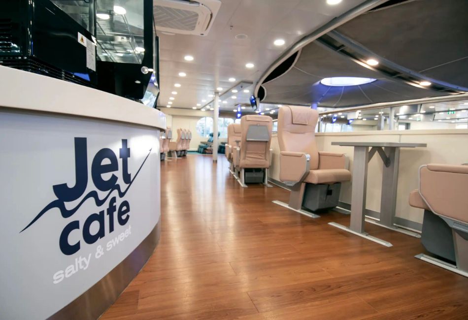 Jet Café on a SeaJets ferry with modern seating and tables, offering passengers a comfortable place to relax during the journey.