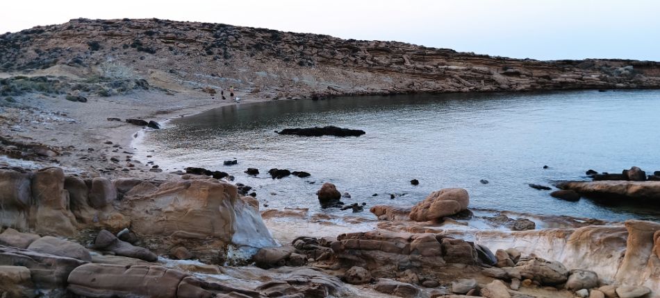 Secluded bay next to Faraklo geological park in Lemnos, surrounded by rocky formations and calm waters.