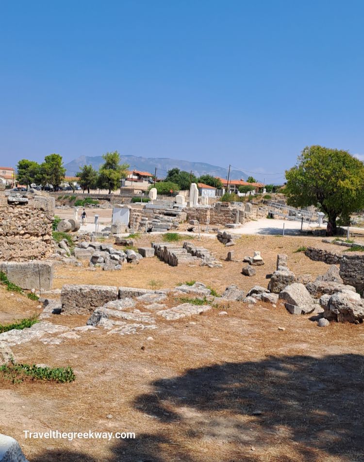 The Bema in Ancient Corinth with distant mountains and a sunny blue sky.