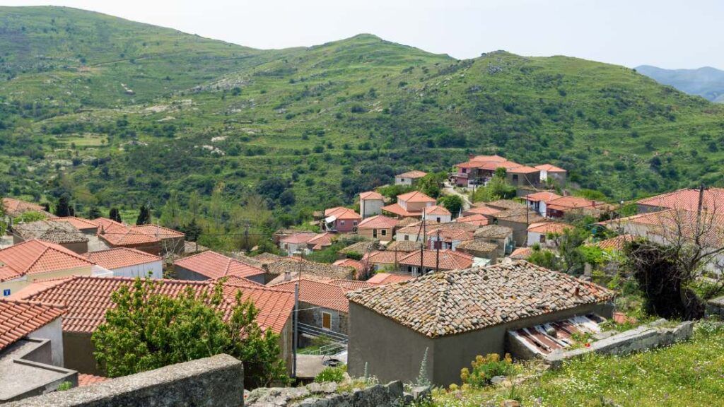 Scenic view of Katalakko village in Lemnos, with traditional red-tiled rooftops and lush green hills.