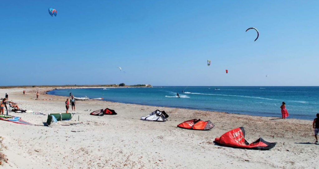 Keros Beach in Lemnos, filled with kitesurfers enjoying the waves and windy conditions.