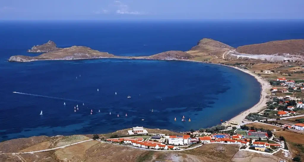 Aerial view of Platy Beach in Lemnos, showing its curved bay and vibrant blue waters.