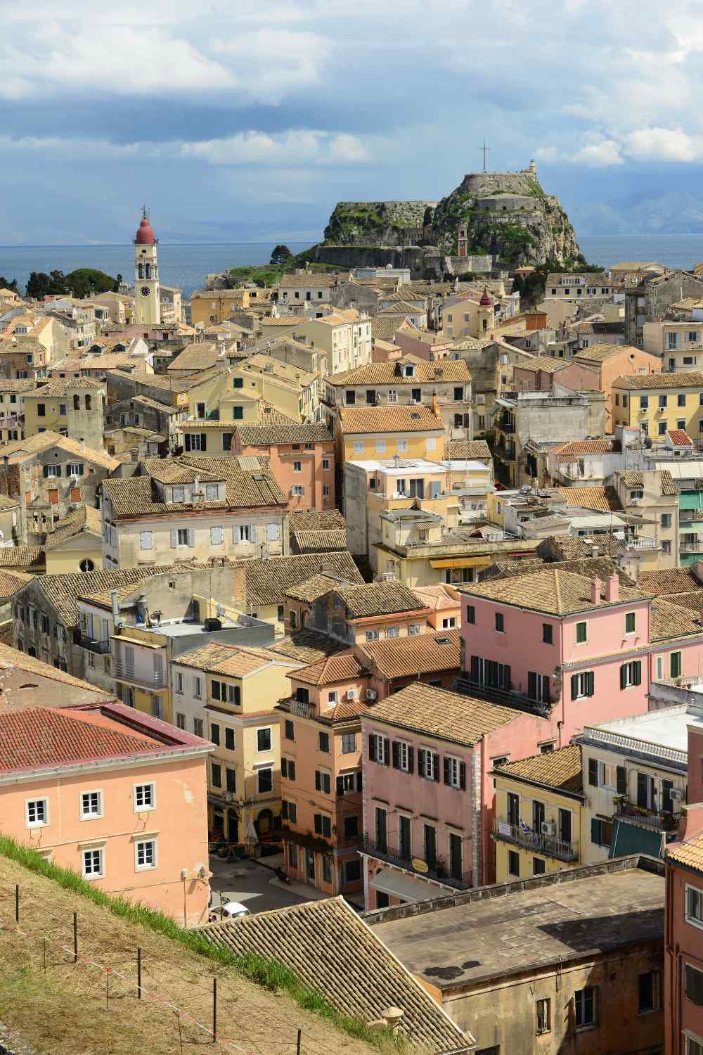 Corfu townscape with historic buildings, colorful facades, and a fortress in the background. Which Greek Island Are You? 