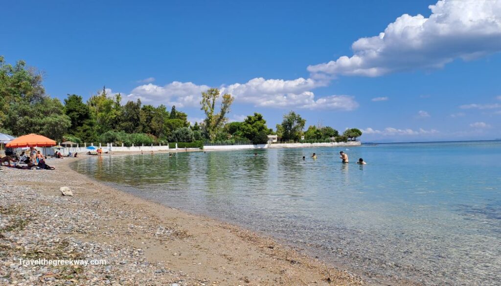 Beautiful beach with swimmers in Chalkida. 