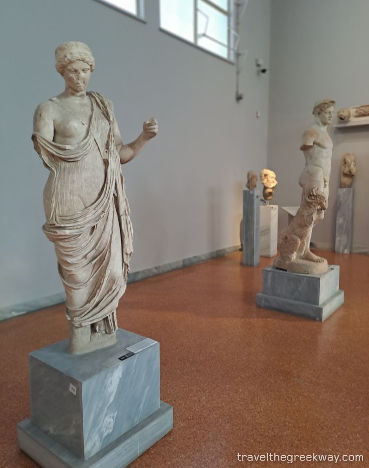 Marble statue of Aphrodite alongside other ancient sculptures in a gallery of the National Archaeological Museum in Athens.