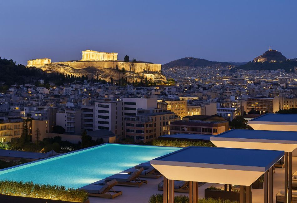 Grand Hyatt pool at night with stunning views of the Acropolis.