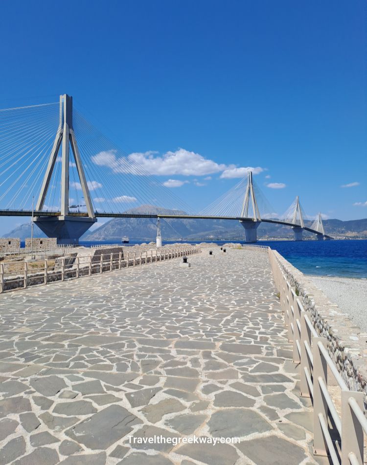 Rio–Antirrio Bridge view from the Rio Castle under a clear blue sky.