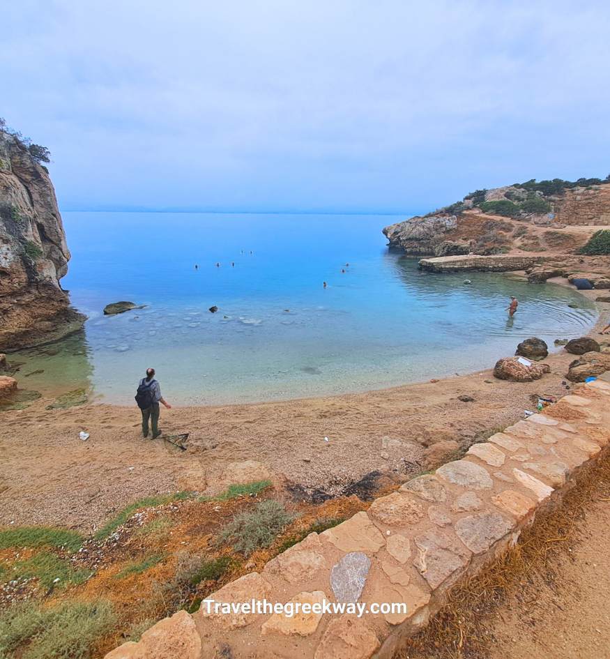 A secluded sandy cove with clear blue water at the Heraion of Perachora near Loutraki, Peloponnese, Greece.