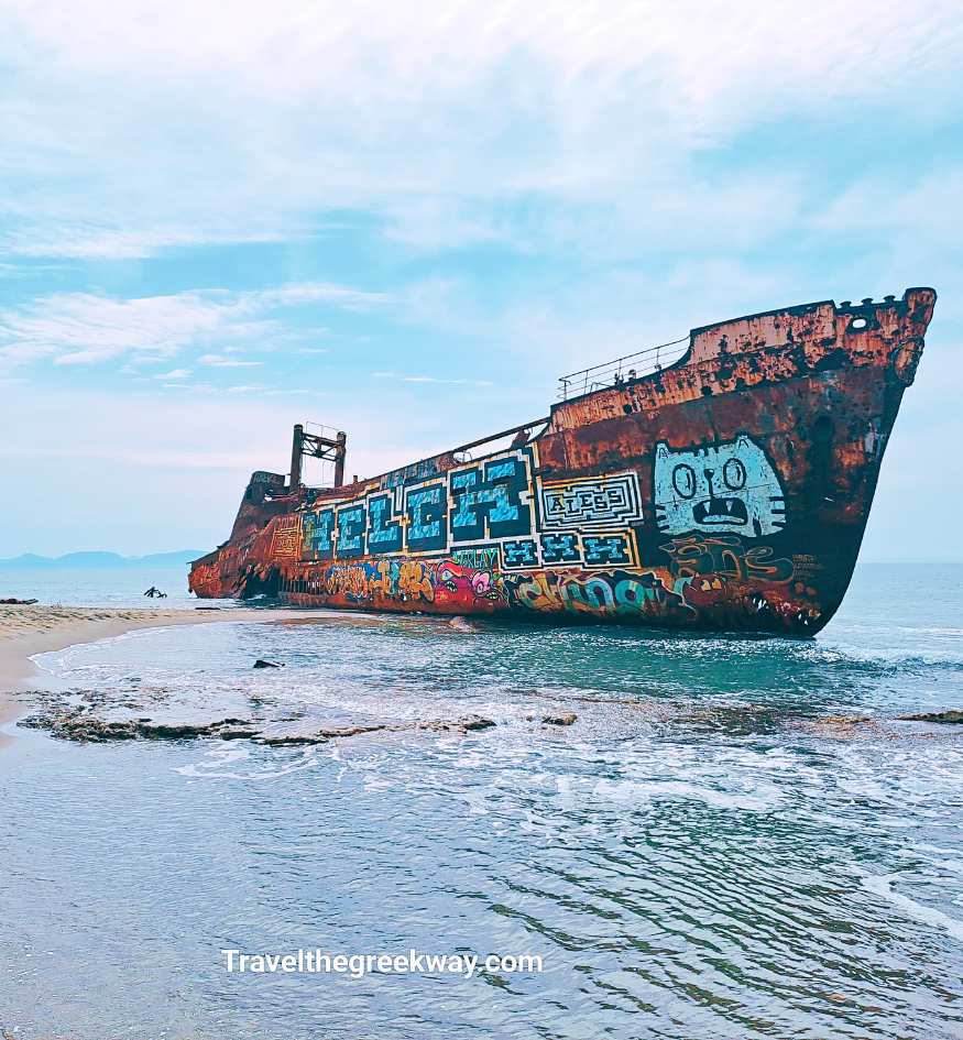 Rusting Dimitrios Shipwreck covered in colorful graffiti on the sandy Valtaki Beach near Gytheio, Laconia, Greece.