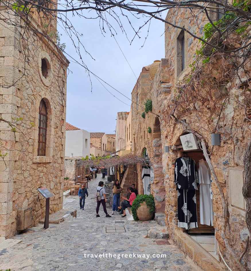 Tourists walking on the cobbled main road of medieval Monemvasia, Peloponnese Greece.