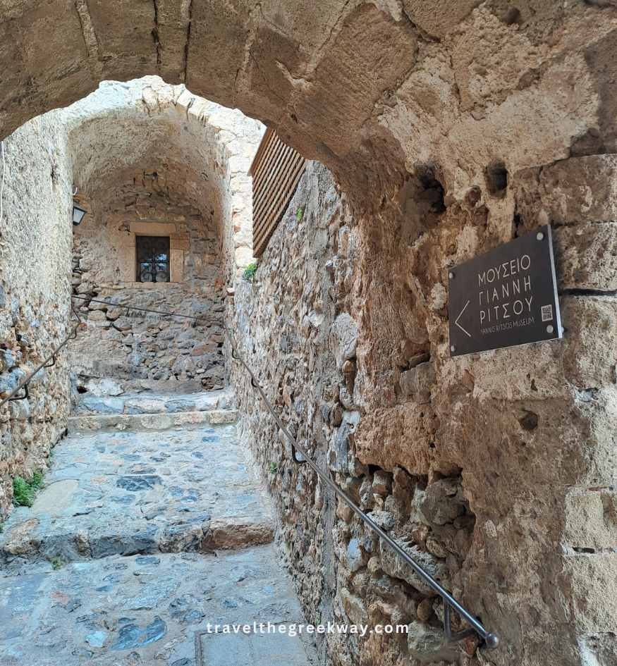 Sign pointing toward the historic Yiannis Ritsos museum in Monemvasia, Peloponnese Greece.