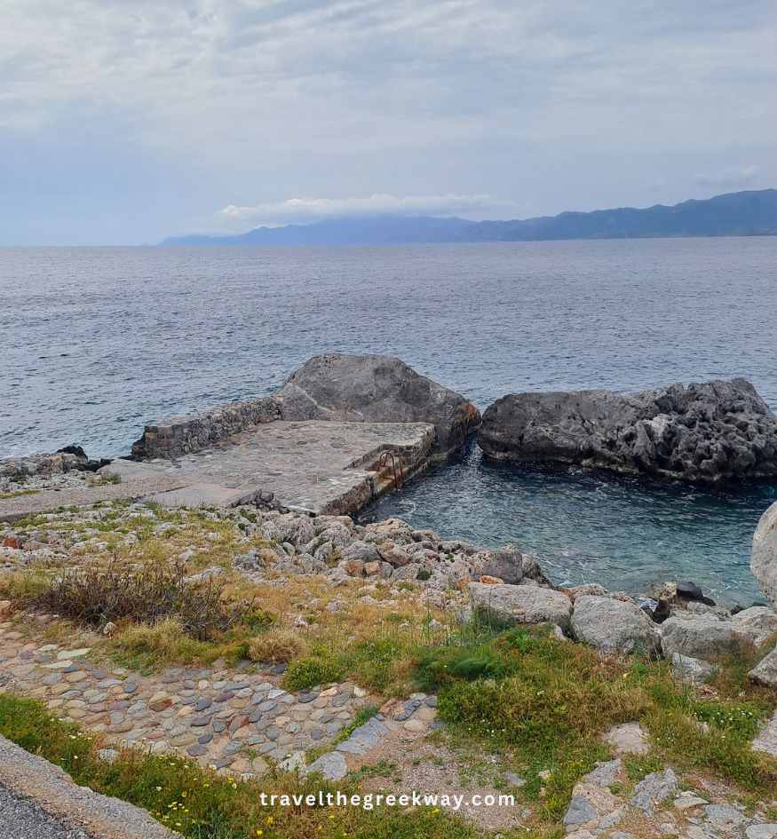 The rocky Portello swimming platform and stone wall next to the sea in Monemvasia, Peloponnese Greece.