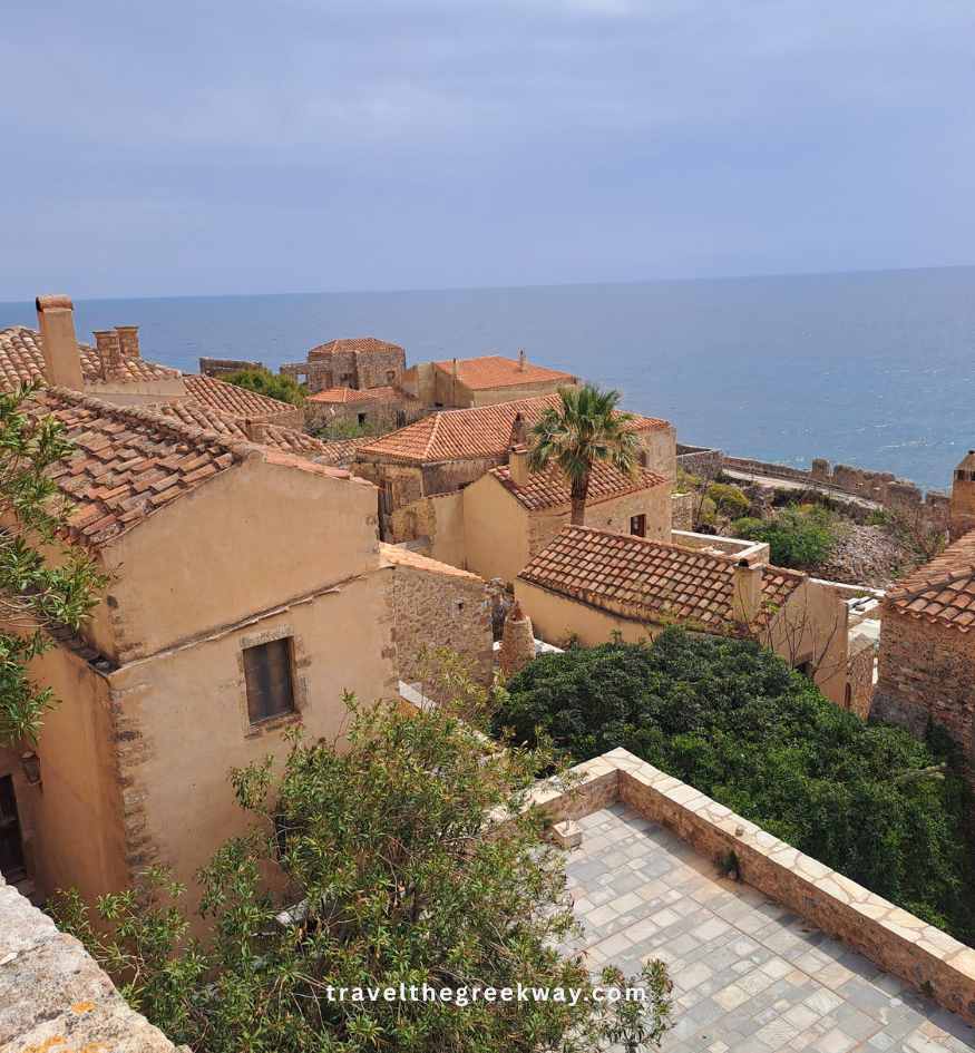 Panoramic view over the historic stone houses and terracotta tile roofs of Monemvasia, Peloponnese Greece.