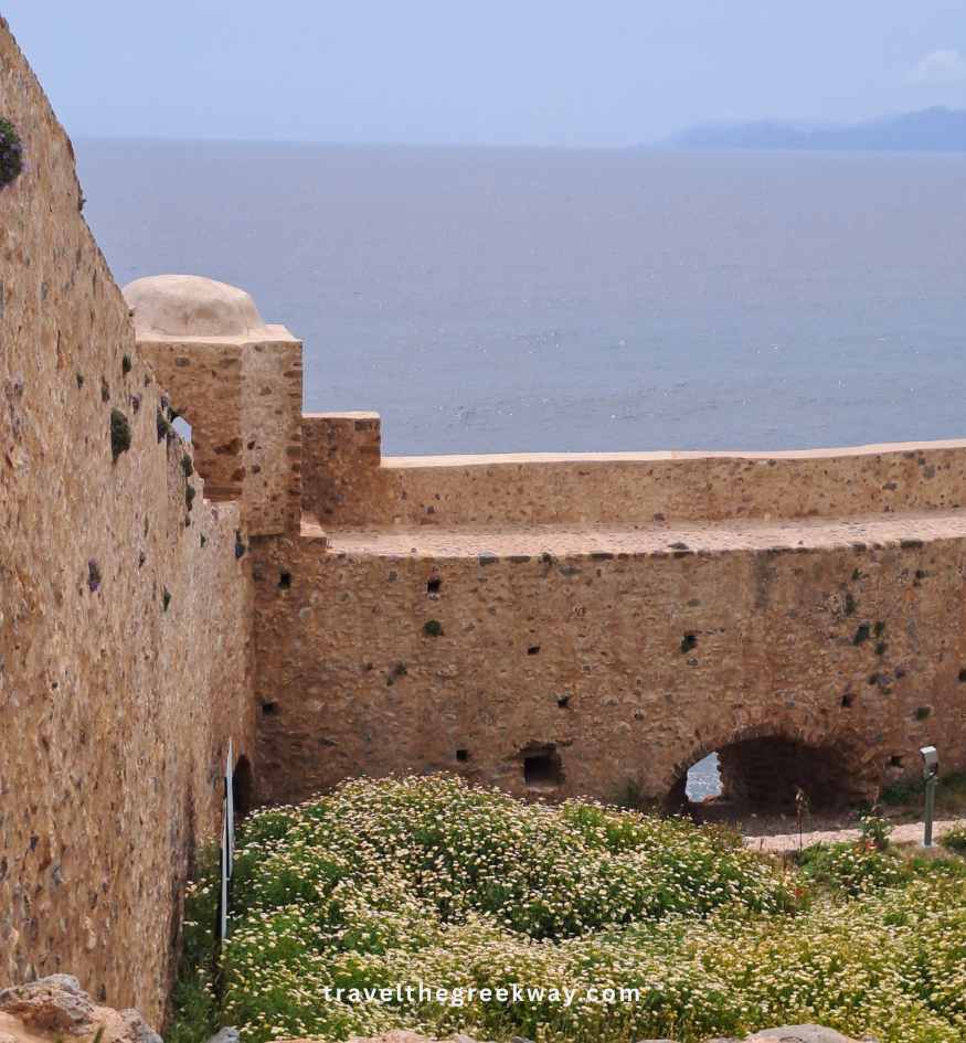 Ancient stone fortress walls and a defensive tower structure in Monemvasia, Peloponnese Greece.