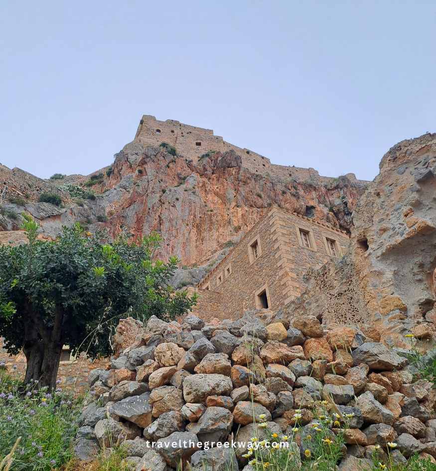 An old stone house built directly into the steep rocky mountain cliff of Monemvasia, Peloponnese Greece.
