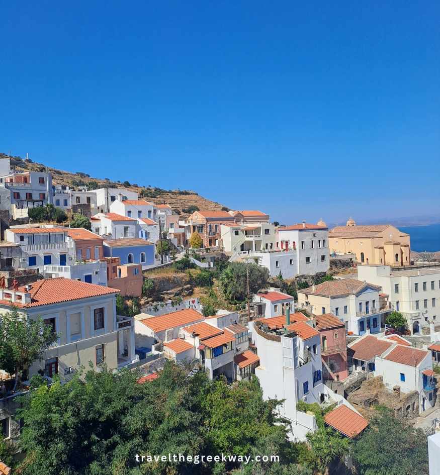 Panoramic view of colorful traditional houses and a church on the hillside of Ioulida, the capital of Kea island in Greece.